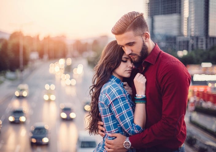 Young couple emracing outside
