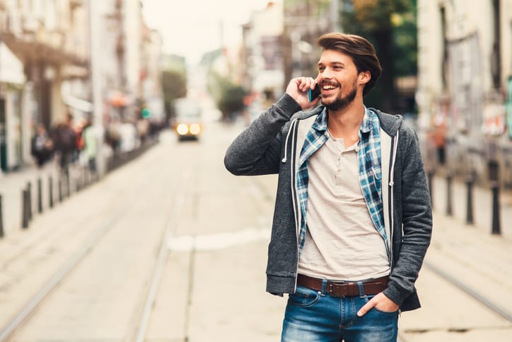 Portrait of a man with casual clothes in urban scene, tallking on phone.