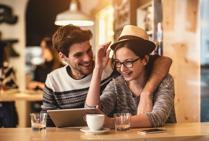 Young couple having fun at the coffee shop