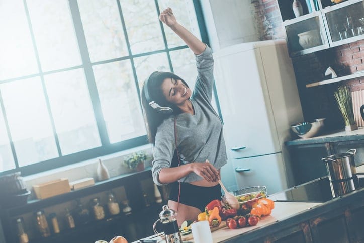 Young black woman dancing kitchen