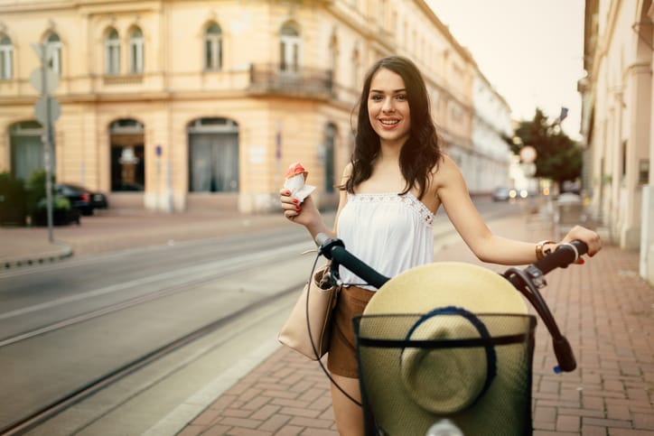 Beautiful woman eating ice cream outdoors