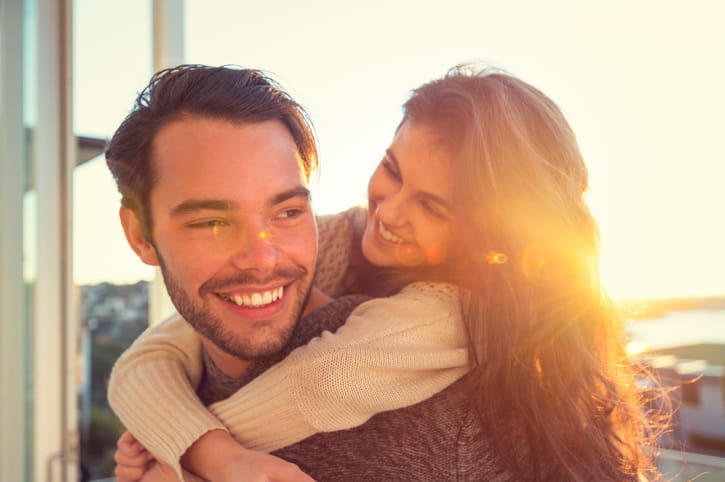 Man giving his girlfriend a piggyback.