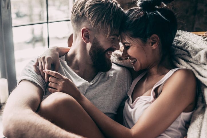 Young couple smiling sitting