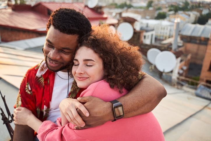 couple embracing on rooftop