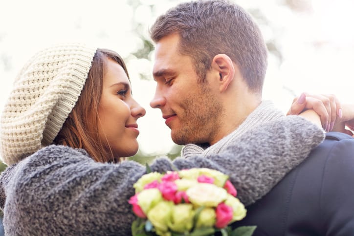 Picture of young couple kissing in the park
