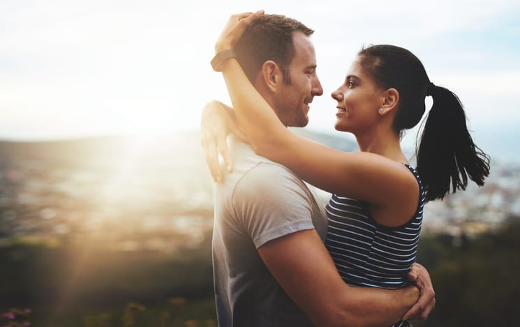Shot of a young couple in a loving embrace outdoors