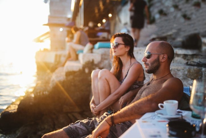 Young people enjoying the summertime by the sea