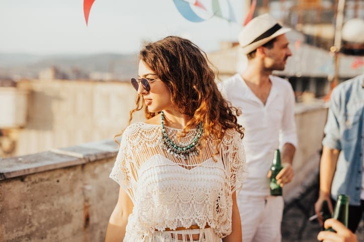 Beautiful curly haired girl looking at the Sun