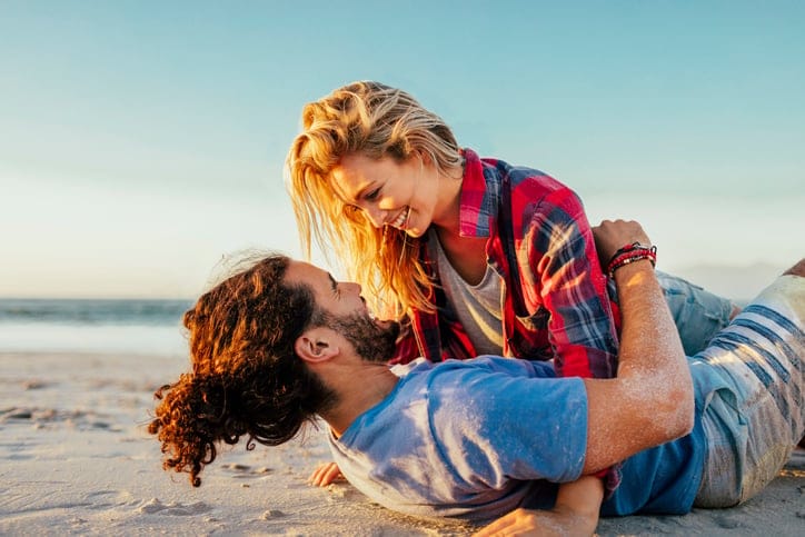 Close up of young couple having fun on the beach