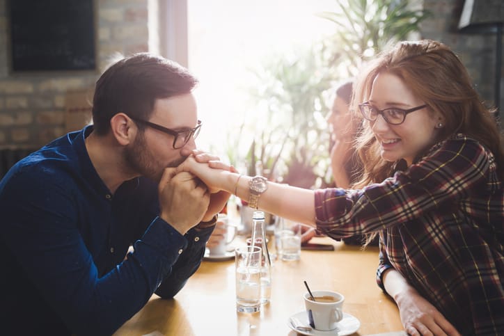 Happy beautiful couple flirting and dating in restaurant
