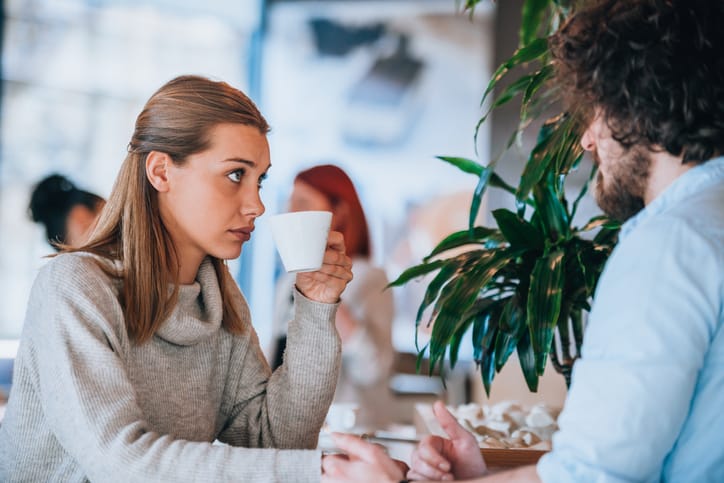 Skeptical woman on coffee date.