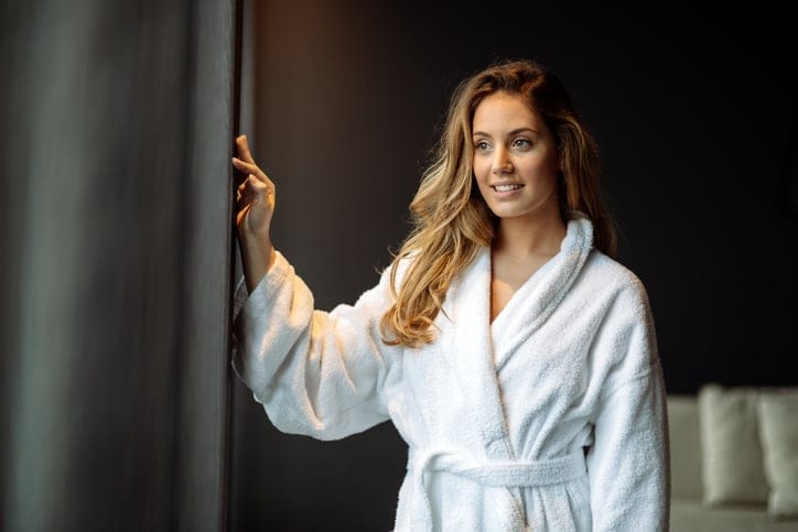 Stunning woman in bathrobe enjoying wellness weekend
