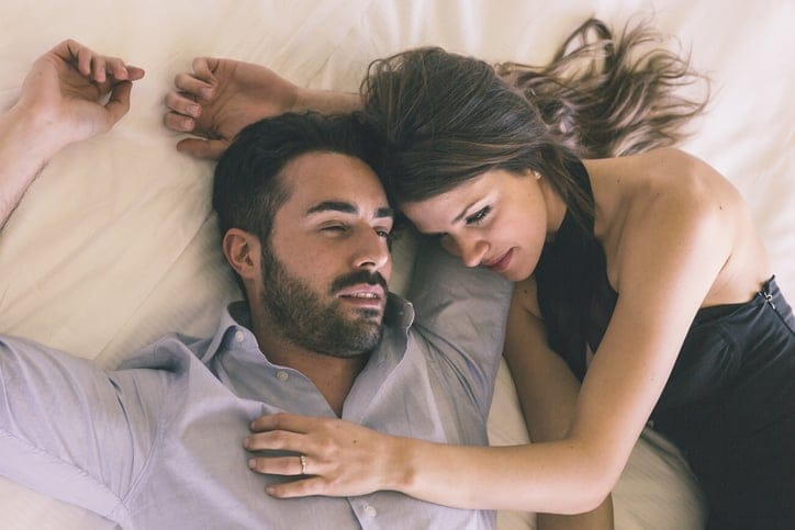 Tired Couple Lying on Bed