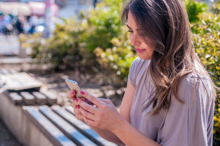 girl text park bench