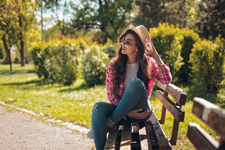 Beautiful girl sitting on a bench