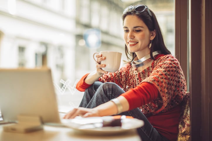 Young woman enjoying a cup of coffee on a rainy day