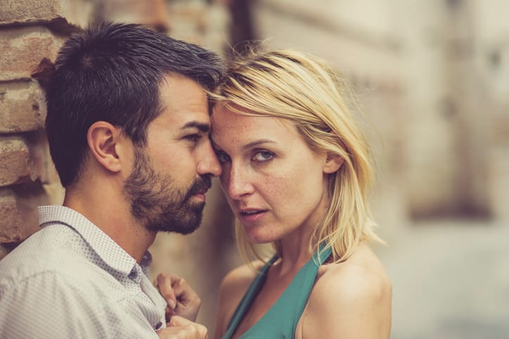 Romantic couple embracing in the street.
