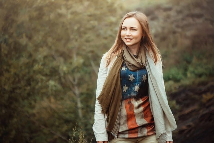 Beautiful and happy girl with American flag dress.
