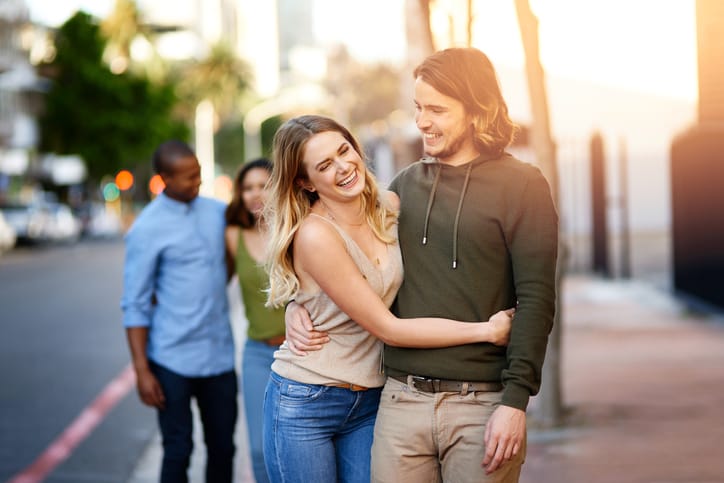Shot of two happy young couples taking a walk through the city