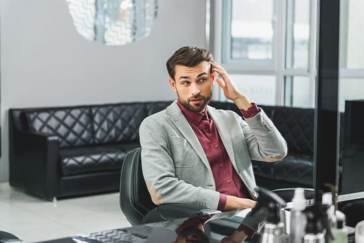 Confident young businessman visiting hairdressers