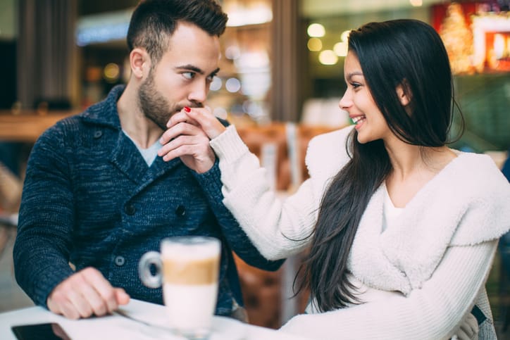 couple kissing having coffee