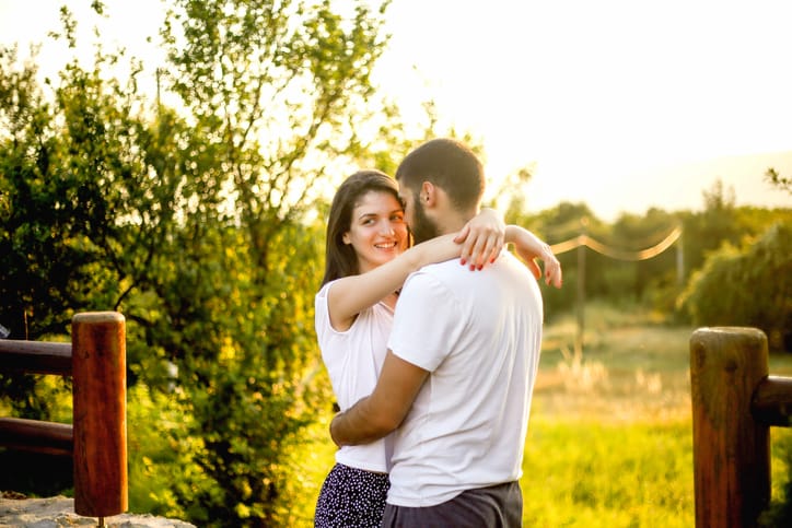 Portrait of young happy beautiful couple on nature