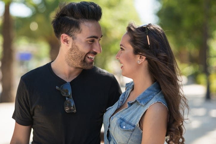 Profile portrait of happy couple in love looking at each other