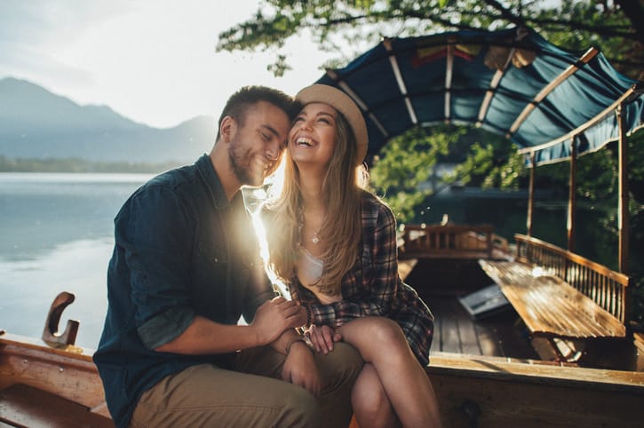 Happy couple lying on a boat at sea. Luxury vacation on a yacht in the islands.