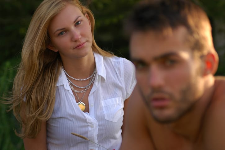 woman staring at man from behind