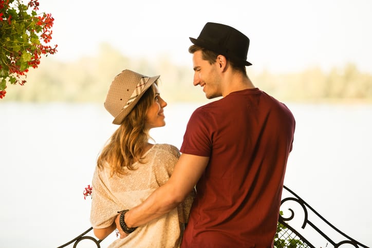 Loving couple by the river on summer day
