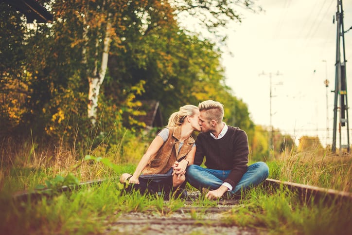 Cute young couple in love outdoors in nature. Cuddling outside a old worn down building outside the city. Contemporary and fresh.