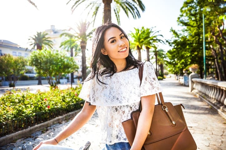 young brunette woman outside in trees