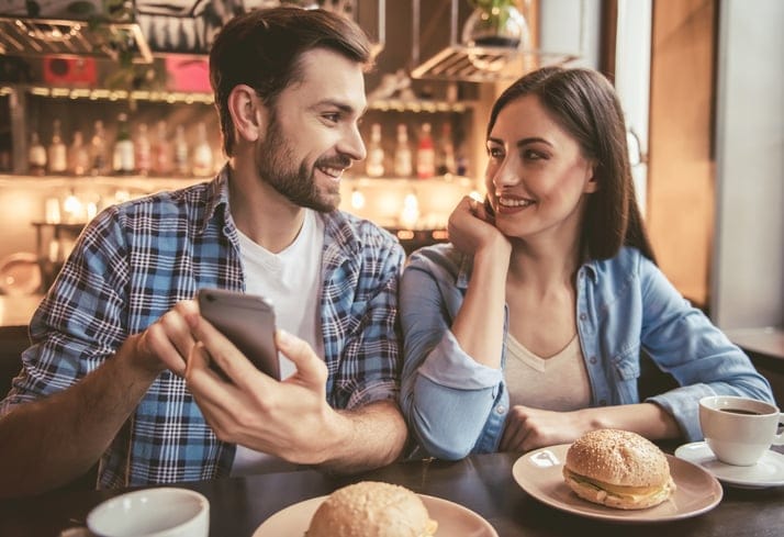 Couple at the cafe smiling at each other