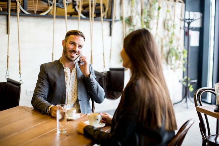 Young couple sitting in a cafe and talking