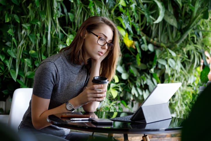 Female Creative contemplating idea while working on a tablet