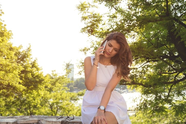 Young attractive woman talking on her cellphone outdoors.