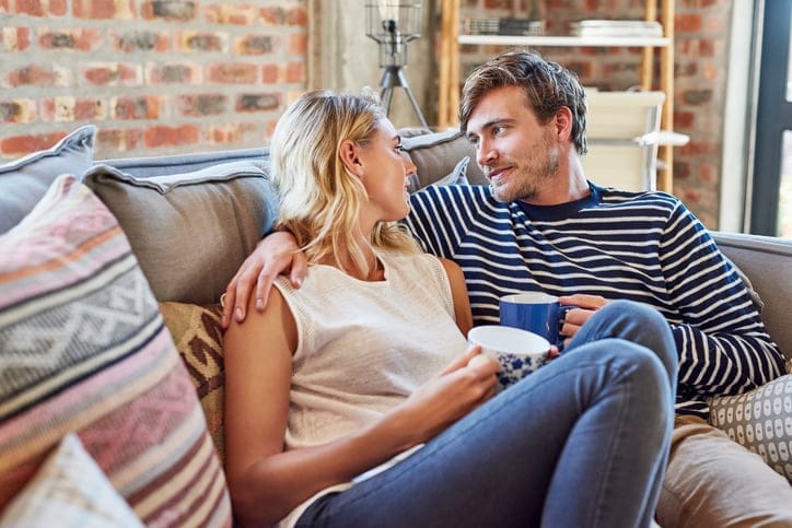 Romantic couple looking at each other on sofa