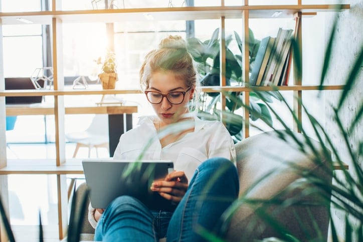 Young independent beautiful woman working in an alternative office