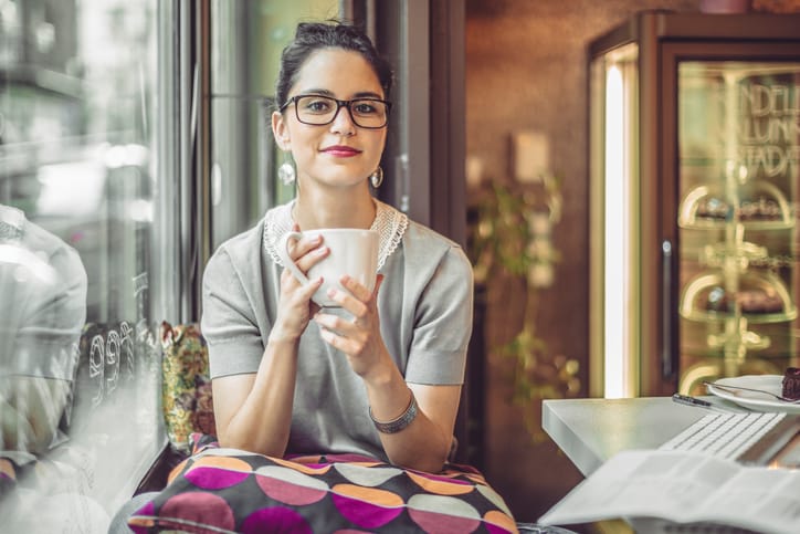Young woman enjoying a cup of coffee on a rainy day