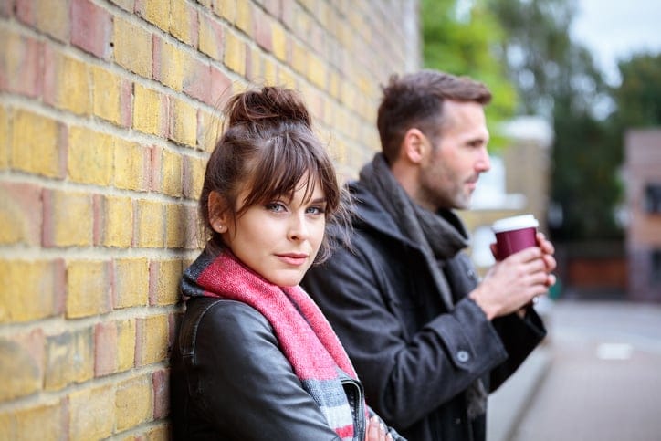Young couple standing outdoors.