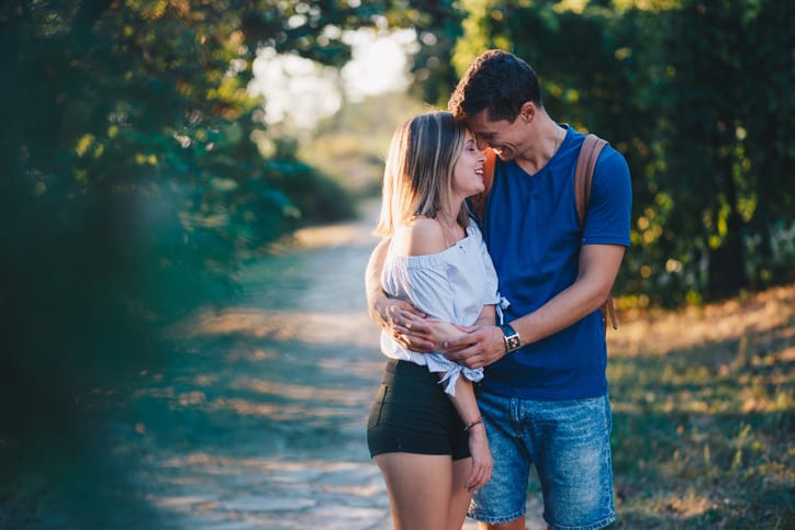 Young couple enjoying in sunny day at city park