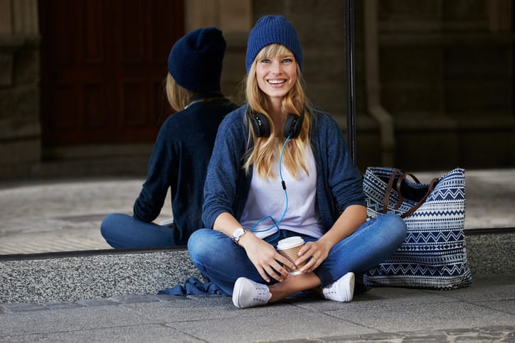 Young woman in city chic, looking at camera