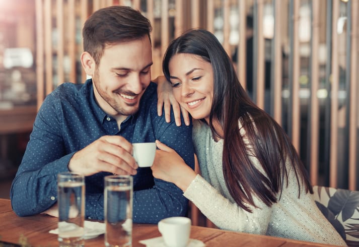 Romantic loving couple drinking coffee, having a date in the cafe. Dating, love, relationships