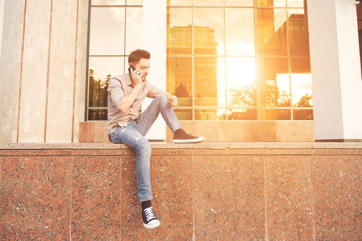 Handsome man outdoors portrait in the city. Warm colors