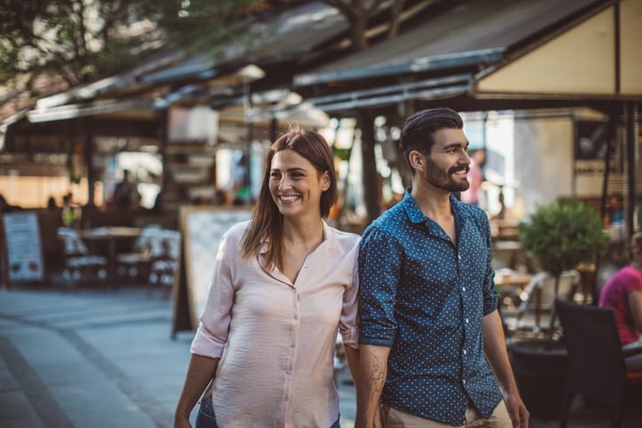 Young couple walking through city