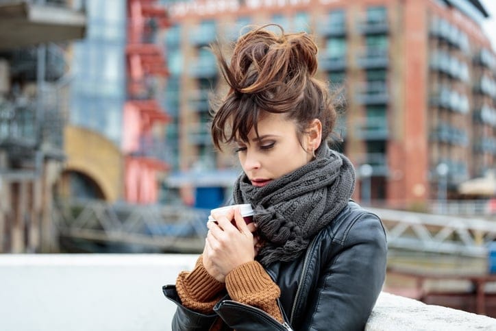 Pensive woman standing outdoors