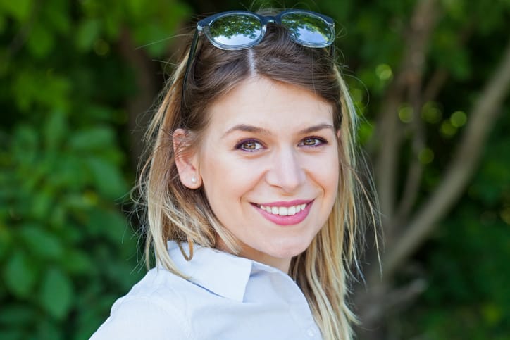 Portrait of a gorgeous young woman smiling at the camera outdoor