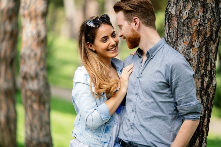 Couple sharing emotions outdoor in green city park