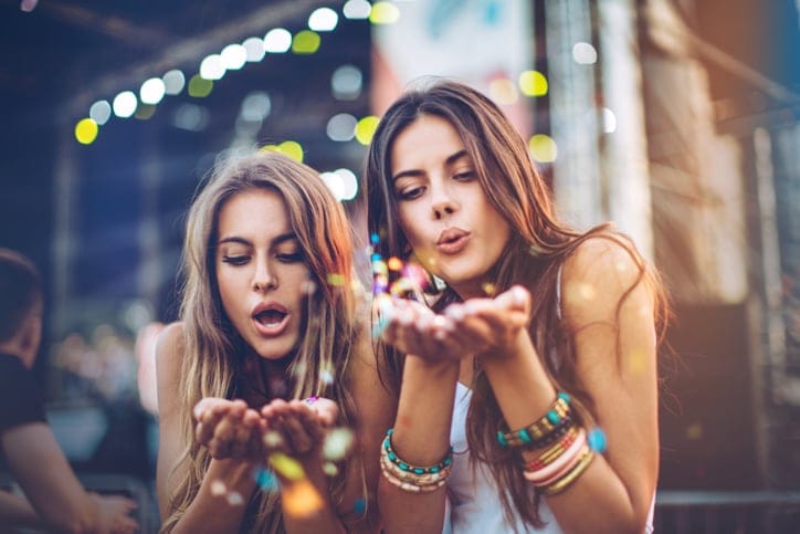 Two friends kissing sparkle dust.