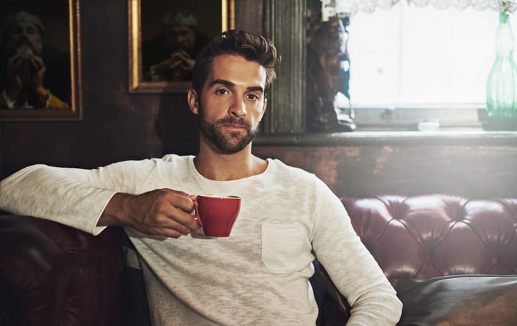Portrait of a handsome man having a cup of coffee at a cafe